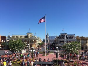 a flag on a flagpole in front of a crowd of people