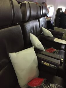 a seat with a white pillow on it