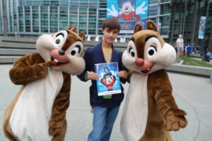 a man standing next to two chipmunks