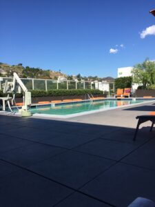 a pool with chairs and a fence