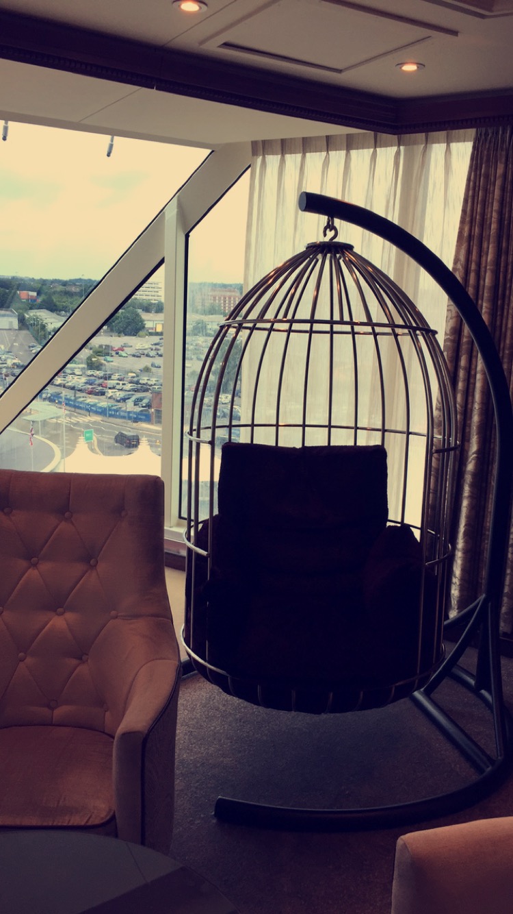 a bird cage chair in a room