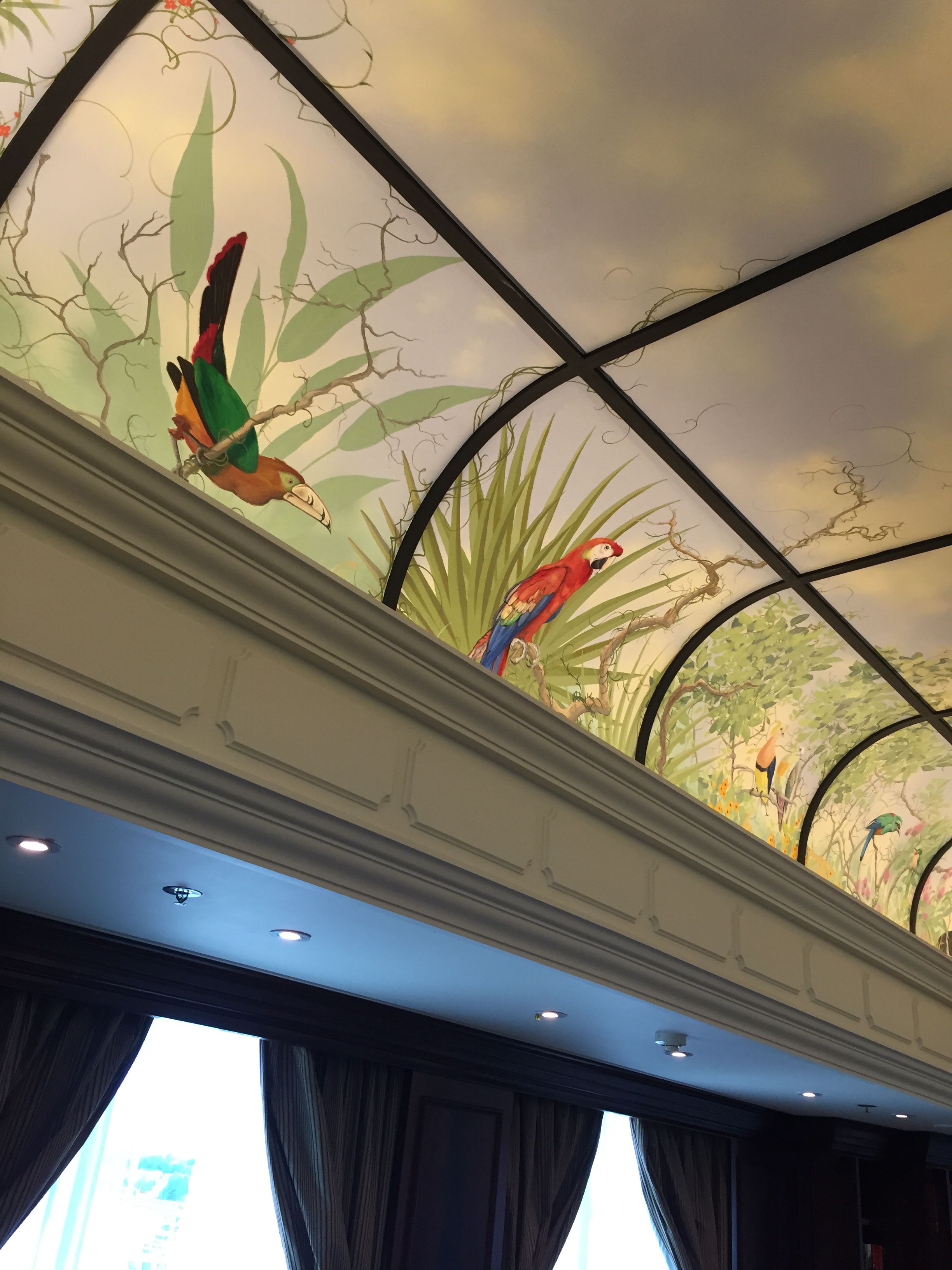 a ceiling with birds and plants painted on it