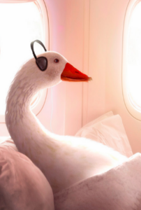 a goose wearing headphones on a bed