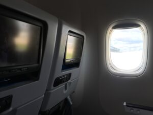 a window in an airplane with a television