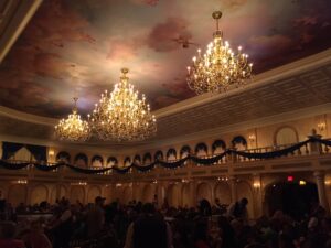 a group of people in a room with chandeliers