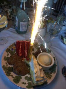 a plate with food and a lit candle