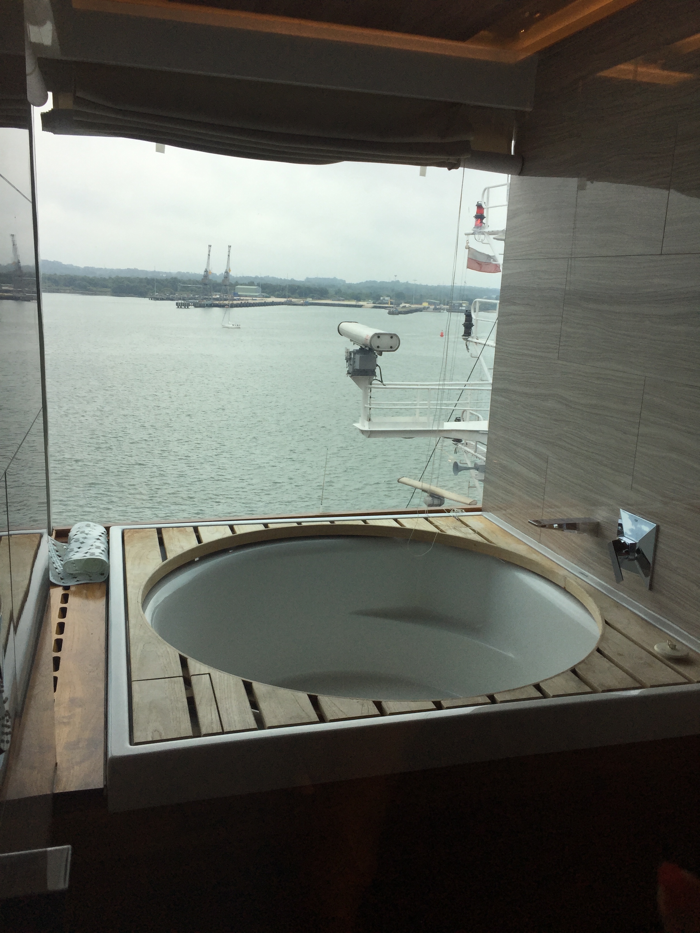 a bathtub with a view of the water from the window
