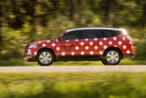 a red car with white dots on it