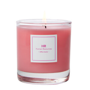 a pink candle in a glass container