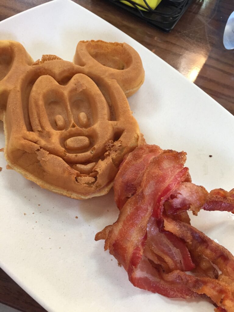 a waffle and bacon on a plate